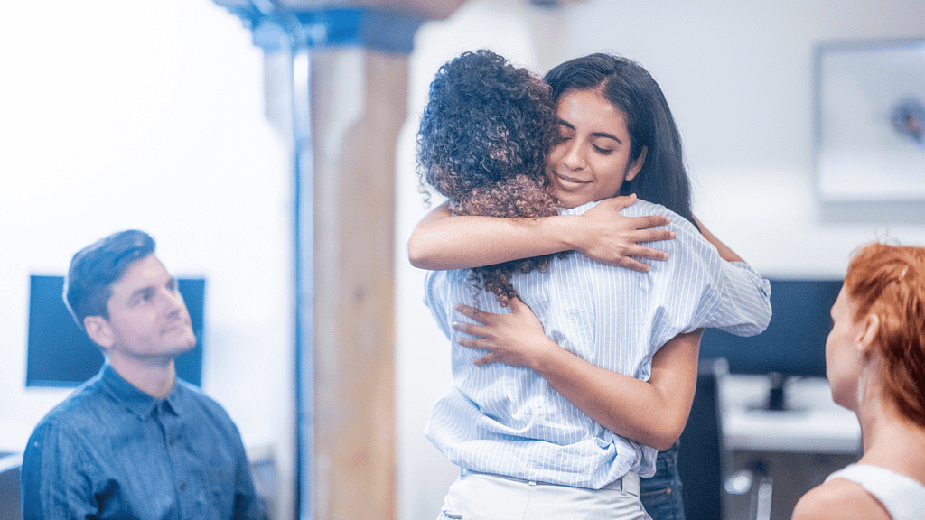 sisters embrace after being apart from studying abroad