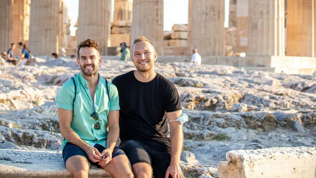 Two guys by Parthenon, Acropolis, Athens Greece. Gay couple on holiday. Travelling during Covid-19