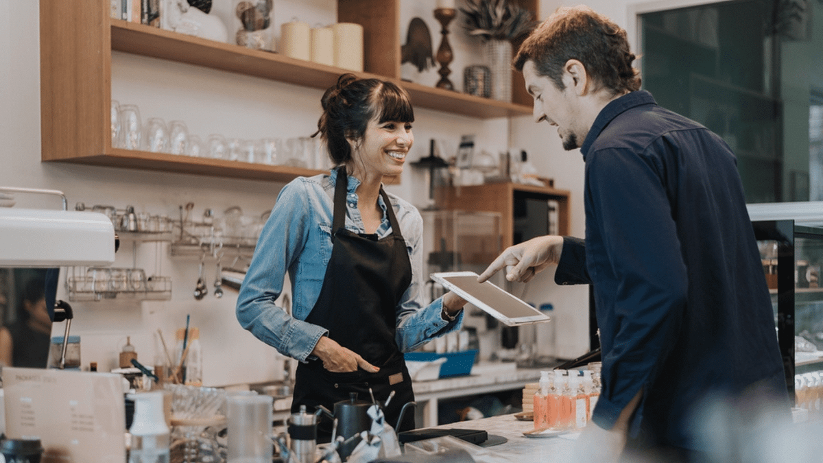 A man ordering coffee from a woman.