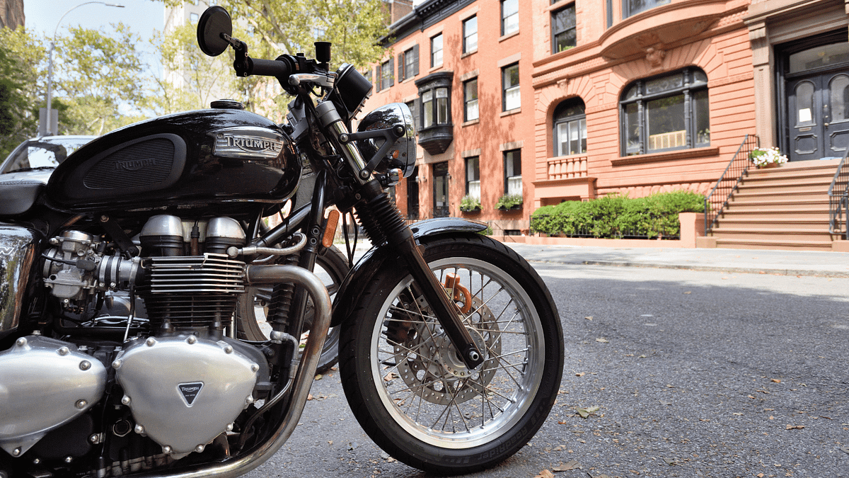 A motorcycle parked on a road in a city.