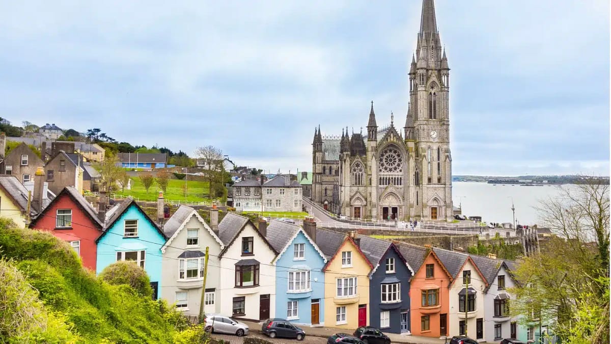 A small coastal town in Ireland, with an old cathedral in the background