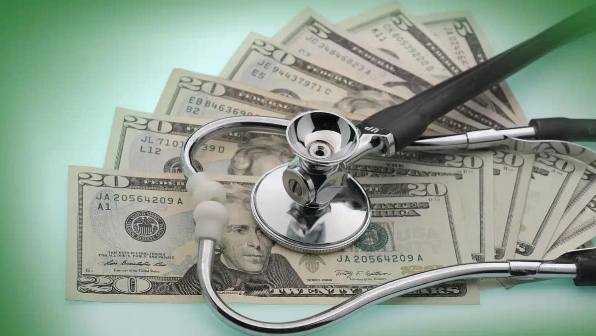 $20 bills and stethoscope describe the US healthcare system