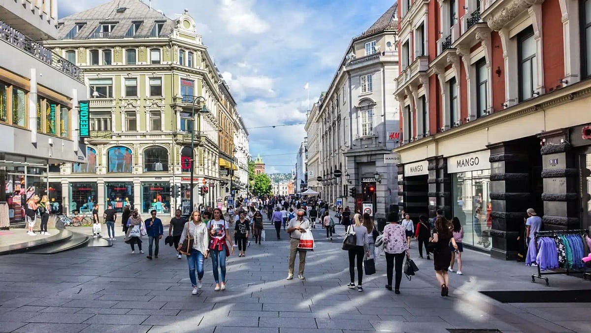 Tourists walk a street in downtown Oslo, Norway
