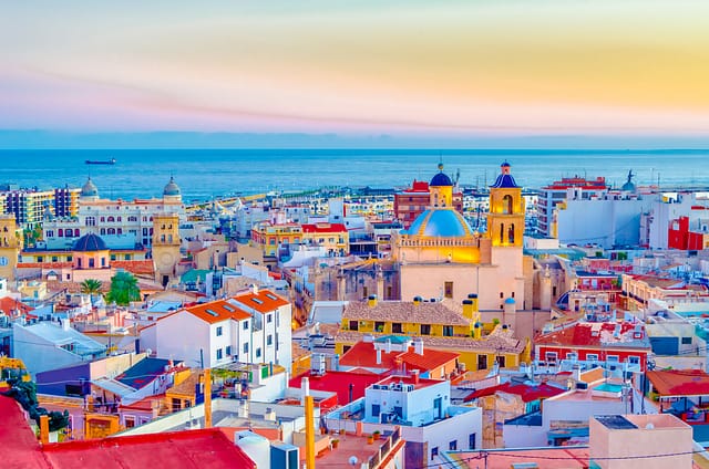 Alicante Cityscape At Dusk Showing The Cathedral With The Sea