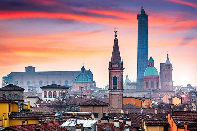 Bologna Italy Rooftop Skyline And Famous Historic Towers At Dusk.
