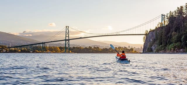 A Serene Kayaking Experience During A Sunrise Near The Iconic