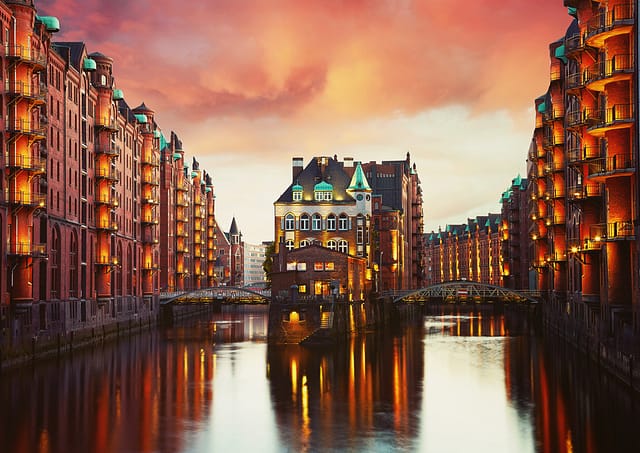 Old Speicherstadt In Hamburg Illuminated At Night. Sunset Background