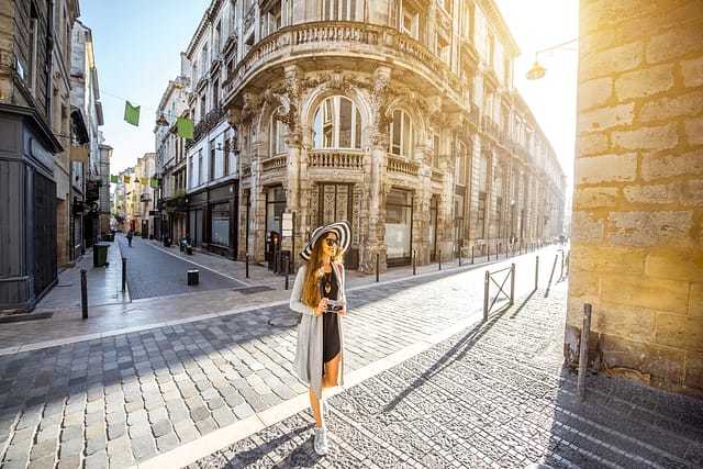 Young Woman Tourist Walking On The Street During The Morning