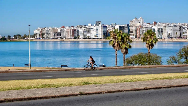 Woman rides her bike across the bay from Montevideo, Uruguay